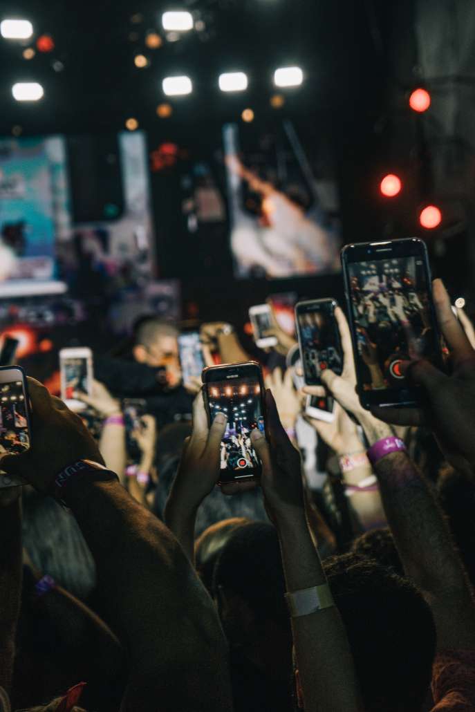 People using their smartphones to take pictures of an event.