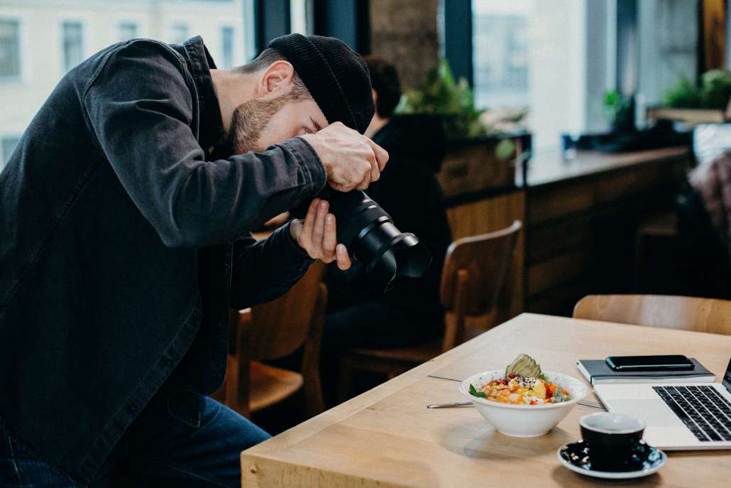 Man taking photos of food